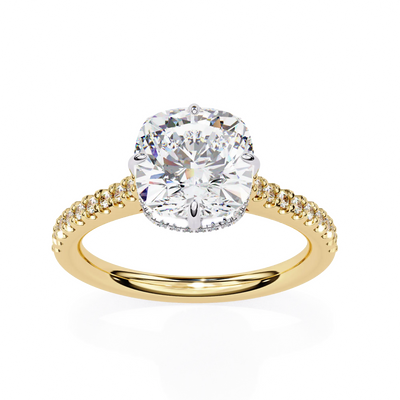 Gold ring with a large diamond and smaller diamonds on the band against a white background