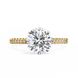 Gold ring with a large diamond and smaller diamonds on the band against a white background