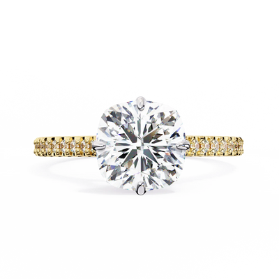 Gold ring with a large diamond and smaller diamonds on the band against a white background