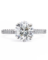 Diamond ring with a large central gemstone and smaller stones on the band against a white background