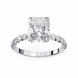 Diamond ring with a large central gemstone and smaller stones on the band against a white background