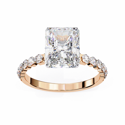 Rose gold ring with a large diamond and smaller diamonds on the band against a white background