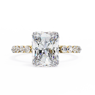 Diamond ring with a large central gemstone and smaller stones on the band against a white background