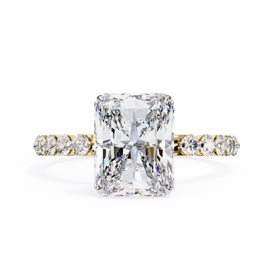 Diamond ring with a large central gemstone and smaller stones on the band against a white background