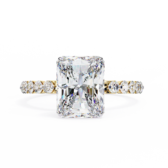 Diamond ring with a large central gemstone and smaller stones on the band against a white background
