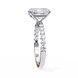 Diamond ring with a large central stone and smaller stones on the band against a white background