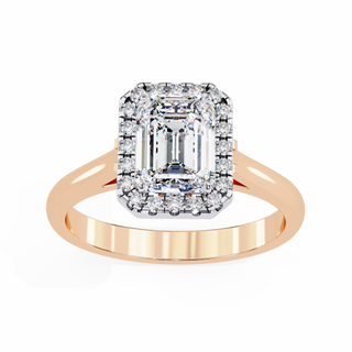 Rose gold ring with a large diamond and smaller diamonds on a white background