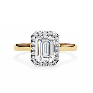 Diamond ring with yellow gold band on a white background