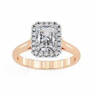 Rose gold ring with a large diamond and smaller diamonds on a white background