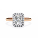 Rose gold ring with a large diamond and smaller diamonds on a white background