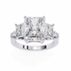 Diamond ring with three princess-cut diamonds on a white background