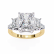 Gold ring with three large diamonds on a white background
