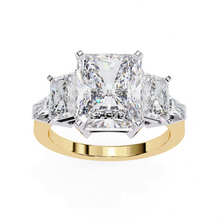 Gold ring with three large diamonds on a white background