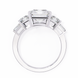 Diamond ring with a central gemstone and smaller stones on a white background