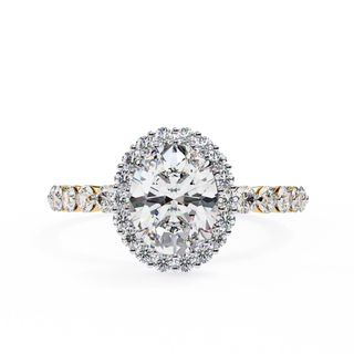 Oval cut lab grown diamond halo engagement ring in yellow gold with round diamond band