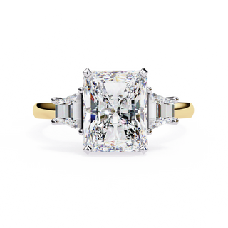 Radiant cut lab grown diamond three-stone engagement ring with tapered baguette side diamonds in yellow gold