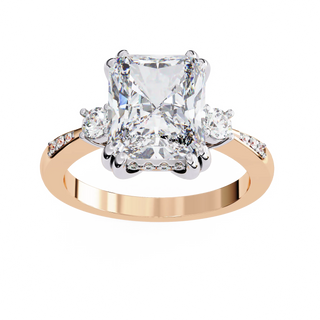 Radiant cut lab grown diamond three-stone engagement ring with round side diamonds and channel-set shoulders in rose gold