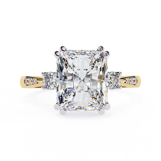 Radiant cut lab grown diamond three-stone engagement ring with round side diamonds and channel-set shoulders in yellow gold