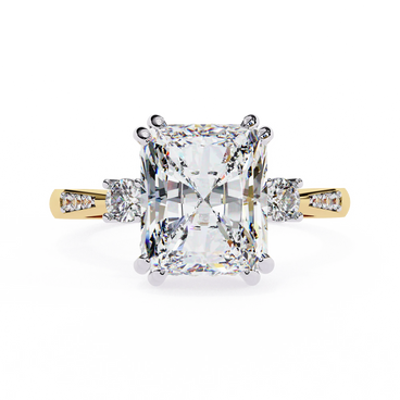 Radiant cut lab grown diamond three-stone engagement ring with round side diamonds and channel-set shoulders in yellow gold