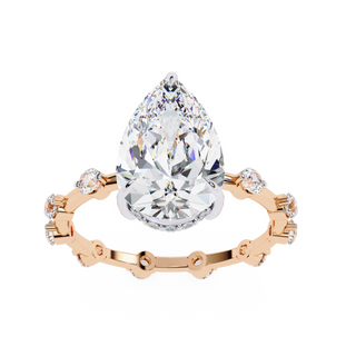 pear diamond hidden halo station ring in rose gold
