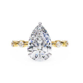 pear diamond hidden halo station ring in yellow gold
