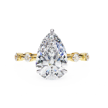 pear diamond hidden halo station ring in yellow gold
