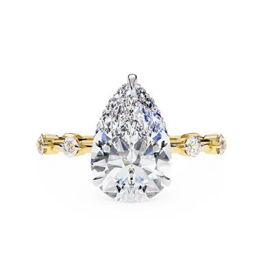 pear diamond hidden halo station ring in yellow gold
