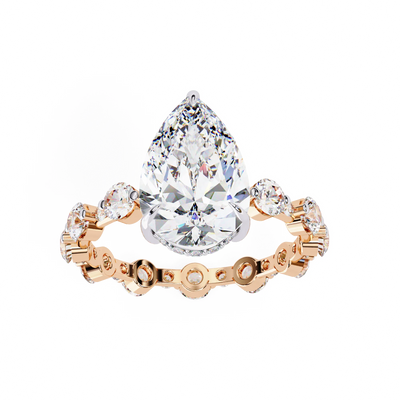 Pear Cut Lab Grown Diamond three-stone engagement ring in rose gold with round diamond shoulders.