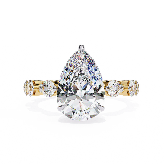 Pear Cut Lab Grown Diamond three-stone engagement ring in yellow gold with round diamond shoulders.
