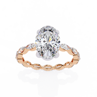 Oval cut lab grown diamond side-stone engagement ring in rose gold with marquise diamond band