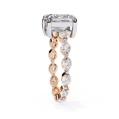 Side profile view of a rose gold princess cut diamond ring with marquise side stones.