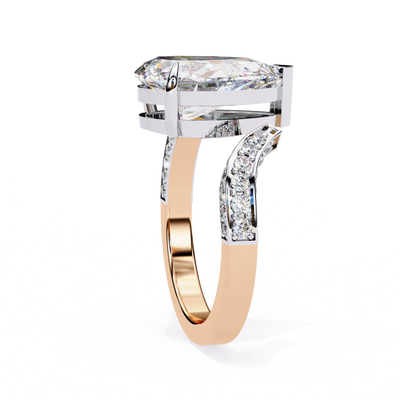 Side profile view of a rose gold pear diamond ring with a split shank pavé band.