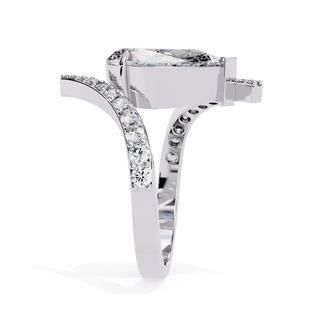 Side profile view of a white gold pear diamond bypass pavé ring.