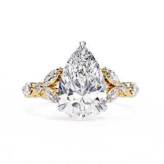 Front-facing view of a yellow gold pear diamond ring with marquise side stones.
