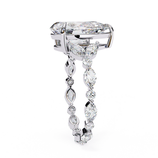 Side profile view of a white gold pear diamond ring with marquise side stones.