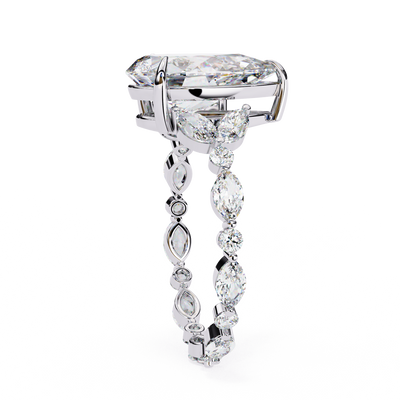 Side profile view of a white gold pear diamond ring with marquise side stones.