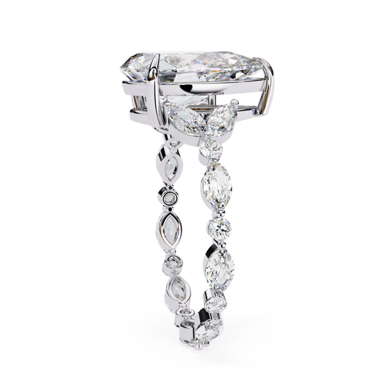 Side profile view of a white gold pear diamond ring with marquise side stones.