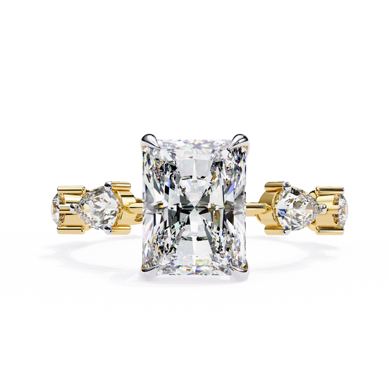 Front-facing view of a yellow gold radiant diamond ring with pear side stones.