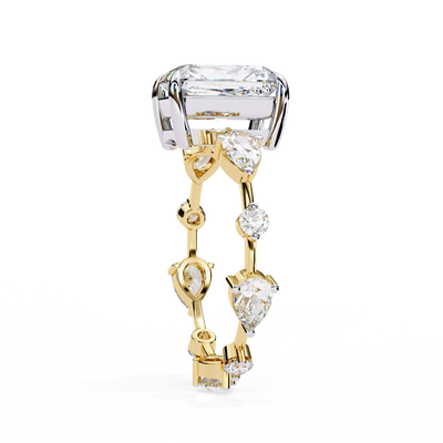 Side profile view of a yellow gold radiant diamond ring with pear side stones.