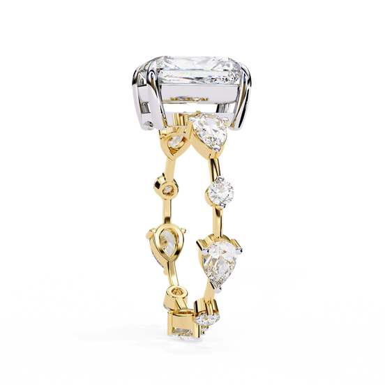 Side profile view of a yellow gold radiant diamond ring with pear side stones.