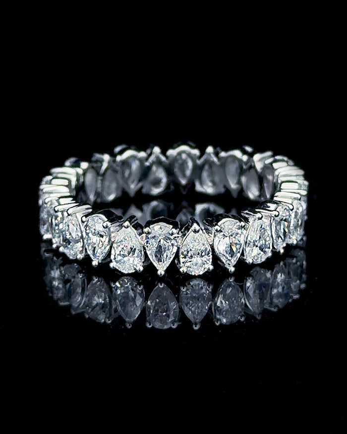 Main: White gold full eternity ring with 20 pear-cut lab grown diamonds on black
Detail: Close-up of pear-cut lab grown diamonds individually prong set around a white gold eternity ring
Side: White gold full eternity band showing continuous pear-shaped lab grown diamonds around the ring