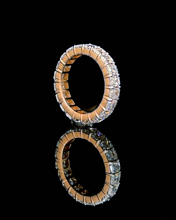 Main: Rose gold emerald-cut eternity ring with lab grown diamonds photographed on black
Detail: Close-up of emerald-cut lab grown diamonds in a rose gold full eternity setting
Side: Rose gold eternity ring profile with individually prong-set emerald lab grown diamonds