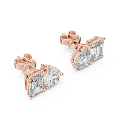 Side profile of rose gold asymmetrical pear and emerald cut diamond studs.