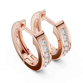Side profile of rose gold sleek channel-set round diamond huggie hoops.
