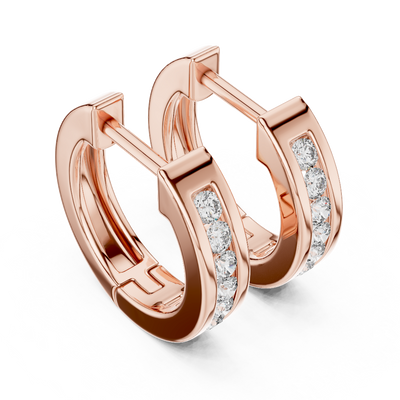 Side profile of rose gold sleek channel-set round diamond huggie hoops.