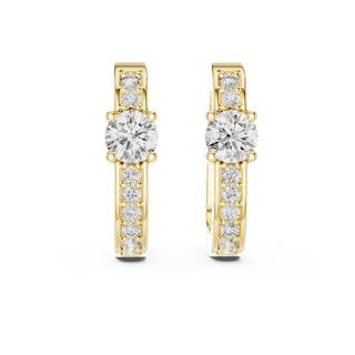 Front view of Luminous Halo diamond huggie earrings in yellow gold with round center stones.
