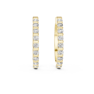 Front view of Timeless Sparkle diamond huggie earrings in yellow gold.