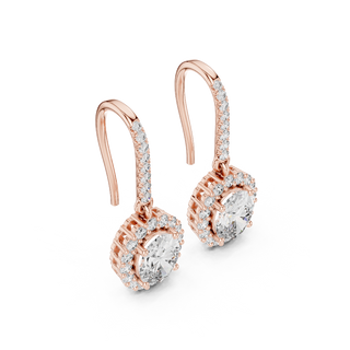 Side profile of rose gold emerald cut halo drop earrings