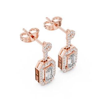 Side profile of rose gold emerald cut halo drop earrings.
