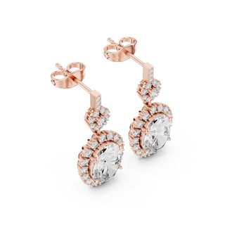 Side profile of rose gold oval ruby drop earrings.